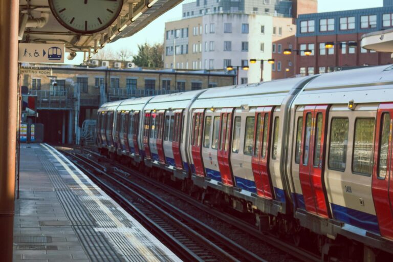 An Underground train is leaving a station in the concept of Twickenham's public transport for new homeowners.