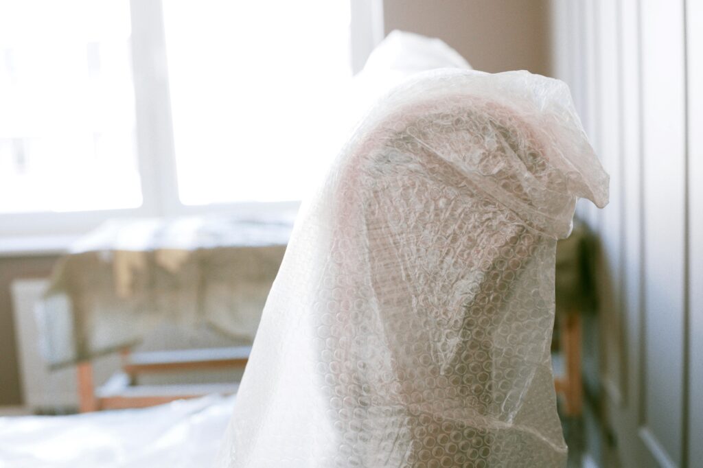 A couch wrapped in bubble wrap