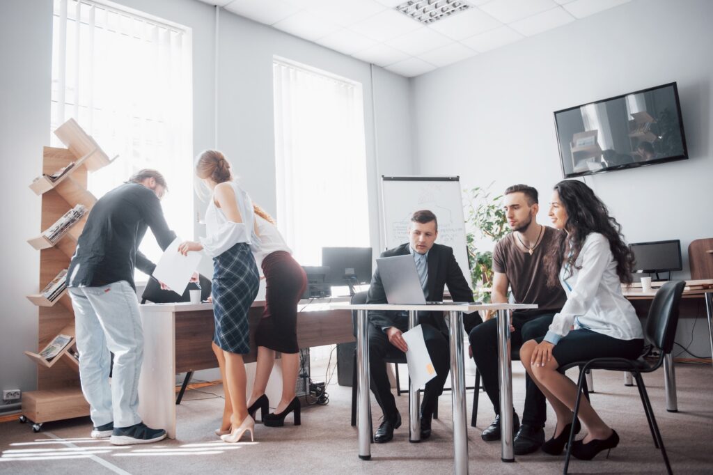 Busy employees in a small office - temporary workspace while moving