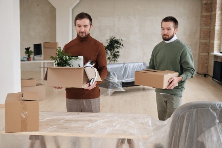 Employees carrying carton of their office items during the move in the concept of 'Benefits of Hiring a Professional Office Removal Service for Your Move to Twickenham'.